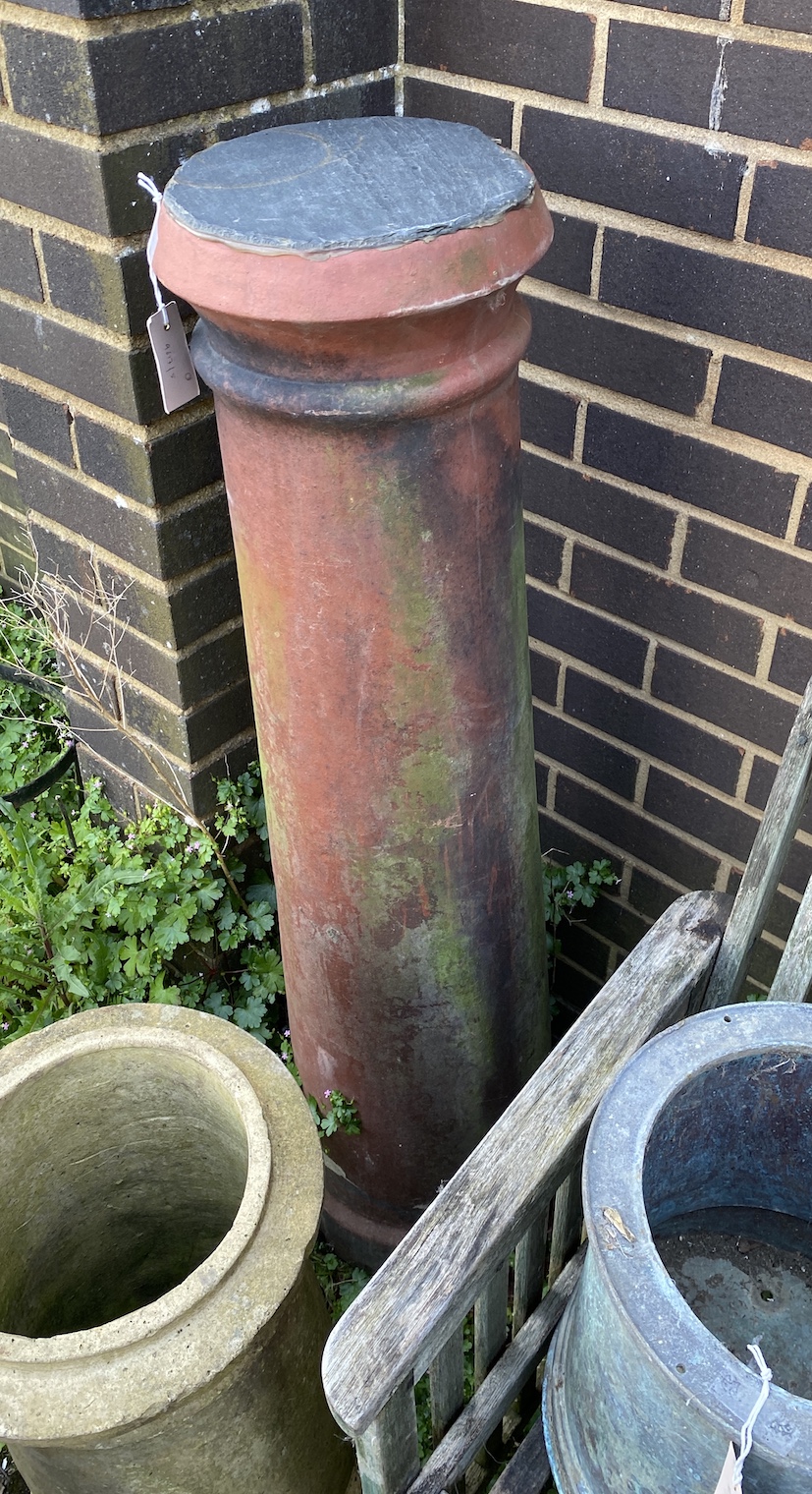 Three earthenware chimney pots, two as garden planters and one as a plinth with slate top, largest 120cm